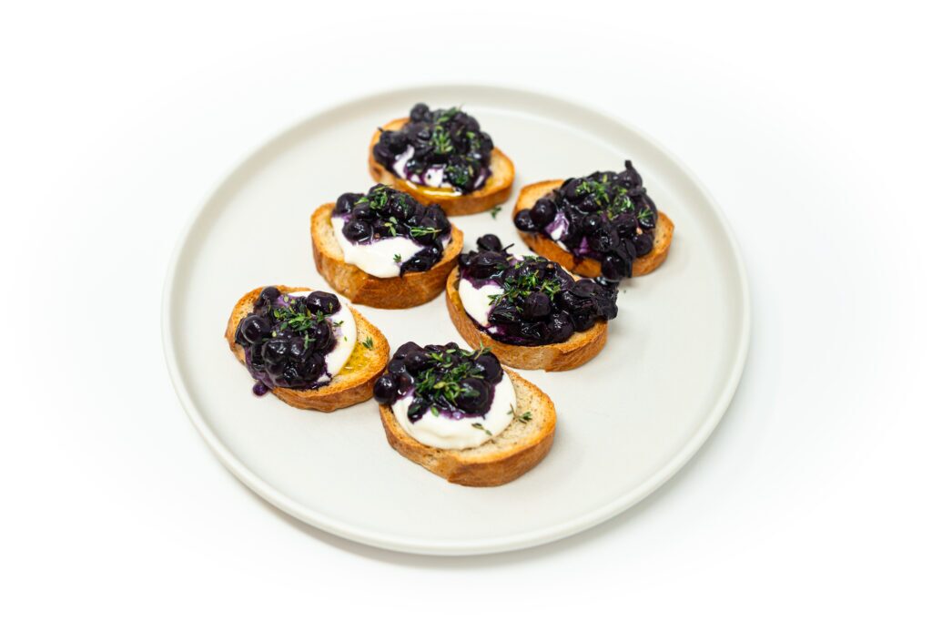 Toasted French bread topped with whipped ricotta, roasted Thomcord grapes, fresh thyme leaves, and a drizzle of honey and olive oil.