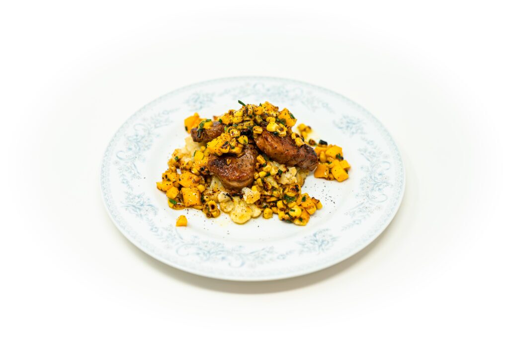 Seared pork medallions over crispy smashed cauliflower topped with charred corn and mango salsa.